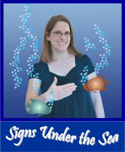 A photo of a smiling white women with glasses and shoulder length brown hair appears on the left. She is signing FISH in American Sign Language, as cartoon fish swim around her.
